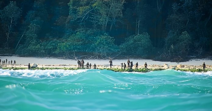 A group of the Sentinelese stand on the shores of their island in the Indian Ocean.